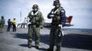 Northrop Grumman test pilots Bruce McFadden (L) and Dave Lorenz are pictured with their arm-mounted controllers after they successfully launched an X-47B pilot-less drone combat aircraft for the first time off an aircraft carrier, the USS George H. W. Bush, in the Atlantic Ocean off the coast of Virginia, May 14, 2013. The U.S. Navy made aviation history on Tuesday by catapulting an unmanned jet off an aircraft carrier for the first time, testing a long-range, stealthy, bat-winged plane that represents a jump forward in drone technology. REUTERS/Jason Reed (UNITED STATES - Tags: MILITARY SCIENCE TECHNOLOGY) Published: Kvě. 14, 2013, 6:52 odp.