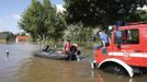 Firefighters move a boat into the water to search for residents after the river Elbe flooded the village of Kabelitz, north of Magdeburg June 10, 2013. Tens of thousands of people have been forced to leave their homes and there have been at least a dozen deaths as a result of floods that have hit Germany, Austria, Slovakia, Poland and the Czech Republic over the past week. REUTERS/Fabrizio Bensch (GERMANY - Tags: DISASTER ENVIRONMENT)