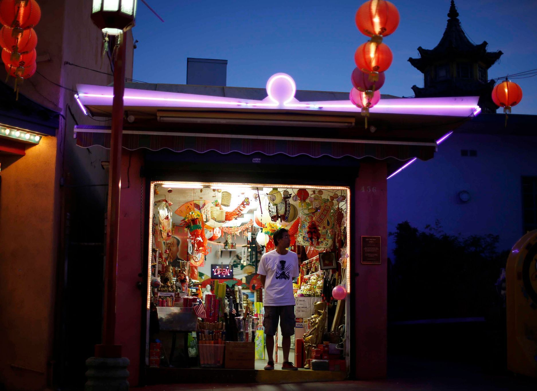 Man stands in a store selling lanterns in Chinatown in Los Angeles, California