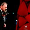 Swedish director Roy Andersson kisses his Golden Lion prize for his movie &quot;A Pigeon Sat on a Branch Reflecting on Existence&quot; during the award ceremony at the 71st Venice Film Festival