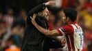 Atletico Madrid's Diego Costa celebrates with coach Diego Simeone (L) after scoring a penalty goal against Chelsea during their Champion's League semi-final second leg so