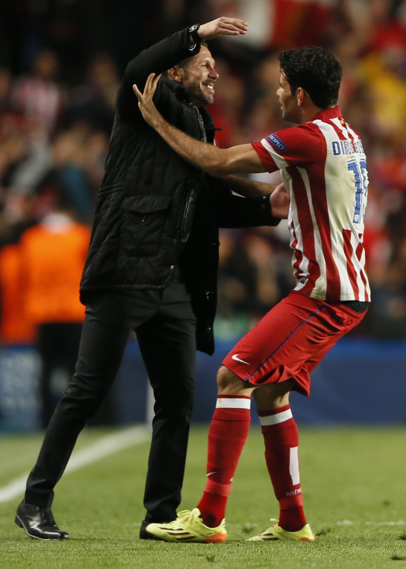 Atletico Madrid's Lopez celebrates with coach Simeone after scoring penalty against Chelsea in Champion's League semi-final second leg soccer match in London