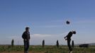 Boys play soccer on the outskirts of the Chechen capital Grozny April 27, 2013. The naming of two Chechens, Dzhokhar and Tamerlan Tsarnaev, as suspects in the Boston Marathon bombings has put Chechnya - the former site of a bloody separatist insurgency - back on the world's front pages. Chechnya appears almost miraculously reborn. The streets have been rebuilt. Walls riddled with bullet holes are long gone. New high rise buildings soar into the sky. Spotless playgrounds are packed with children. A giant marble mosque glimmers in the night. Yet, scratch the surface and the miracle is less impressive than it seems. Behind closed doors, people speak of a warped and oppressive place, run by a Kremlin-imposed leader through fear. Picture taken April 27, 2013. REUTERS/Maxim Shemetov (Russia - Tags: SOCIETY POLITICS) ATTENTION EDITORS: PICTURE 35 OF 40 FOR PACKAGE 'INSIDE MODERN CHECHNYA'. SEARCH 'REBUILDING CHECHNYA' FOR ALL IMAGES Published: Kvě. 1, 2013, 8:22 dop.