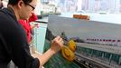 World News - May 2, 2013 HONG KONG, May 2, 2013 A painter draws the scene where a huge rubber duck floating on the waters at the Victoria Harbor in Hong Kong, south China, May 2, 2013. The largest rubber duck was created by Dutch artist Florentijn Hofman, with 18 meters of length, 15 meters of width and height. The duck has visited 12 cities since 2007.