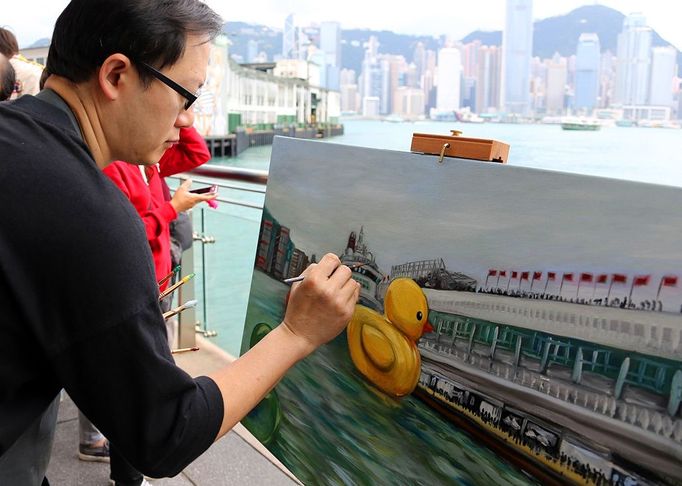 World News - May 2, 2013 HONG KONG, May 2, 2013 A painter draws the scene where a huge rubber duck floating on the waters at the Victoria Harbor in Hong Kong, south China, May 2, 2013. The largest rubber duck was created by Dutch artist Florentijn Hofman, with 18 meters of length, 15 meters of width and height. The duck has visited 12 cities since 2007.