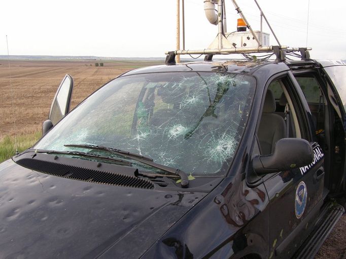 The tornadic storm observed earlier was accompanied by large dangerous hail which smashed the windshield of this National Severe Storms Laboratory instrumented vehicle. Note leaves and mud on side of truck. Wyoming, LaGrange. June 5, 2009. Credit: VORTEX II.