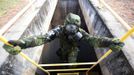 A Brazilian army soldier wearing a chemical suit participates in an anti-terror simulation exercise as part of the preparation for the upcoming 2013 FIFA Confederations Cup in Brasilia. May 22, 2013. About 100 soldiers took part in the exercise which include preventive strikes against chemical, biological and radiological weapons conducted around Mane Garrincha National Stadium, according to an official statement. REUTERS/Ueslei Marcelino (BRAZIL - Tags: SPORT SOCCER MILITARY) Published: Kvě. 22, 2013, 9:42 odp.