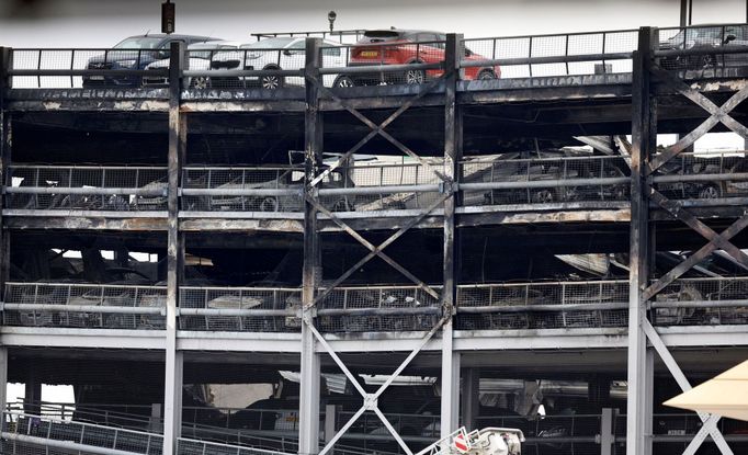 A view shows burnt vehicles in Terminal Car Park 2, following a fire at London Luton Airport, in Luton, Britain, October 11, 2023.  REUTERS/Peter Cziborra