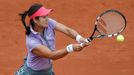 Li Na of China returns a backhand to Kristina Mladenovic of France during their women's singles match at the French Open tennis tournament at the Roland Garros stadium in