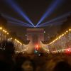 Revellers gather near the Arc de Triomphe on the Champs Elysees Avenue in Paris during New Year celebrations