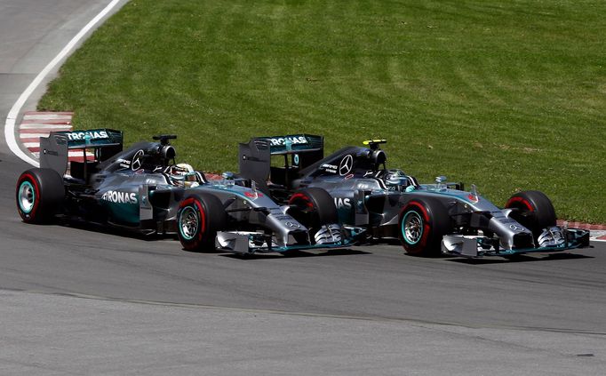 Mercedes Formula One driver Nico Rosberg of Germany (R) cuts inside Mercedes Formula One driver Lewis Hamilton of Britain on the start during the Canadian F1 Grand Prix a