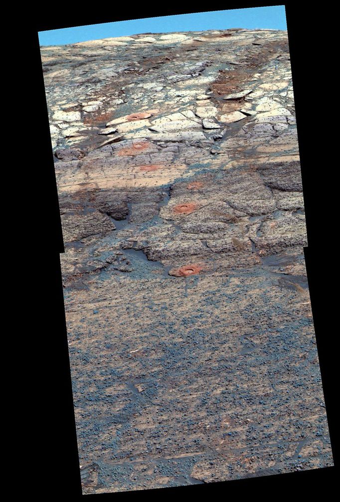 False-Color View of a 'Rat' Hole Trail 7/27/04 This view from the Mars Exploration Rover Opportunity's panoramic camera is a false-color composite rendering of the first seven holes that the rover's rock abrasion tool dug on the inner slope of "Endurance Crater." The rover was about 12 meters (about 39 feet) down into the crater when it acquired the images combined into this mosaic. The view is looking back toward the rim of the crater, with the rover's tracks visible. The tailings around the holes drilled by the rock abrasion tool, or "Rat," show evidence for fine-grained red hematite similar to what was observed months earlier in "Eagle Crater" outcrop holes. Last week, viewers were asked to try seeing as many holes as they could from a black-and-white, navigation-camera image (PIA06716). Most viewers will find it far easier to see the seven holes in this exaggerated color image; the same is true for scientists who are studying the holes from millions of miles away. Starting from the uppermost pictured (closest to the crater rim) to the lowest, the rock abrasion tool hole targets are called "Tennessee," "Cobblehill," "Virginia," "London," "Grindstone," "Kettlestone," and "Drammensfjorden." Opportunity drilled these holes on sols 138 (June 13, 2004), 143 (June 18), 145 (June 20), 148 (June 23), 151 (June 26), 153 (June 28) and 161 (July 7), respectively. Each hole is 4.5 centimeters (1.8 inches) in diameter. This image was generated using the panoramic camera's 750-, 530-, and 430-nanometer filters. It was taken on sol 173 (July 19). Image Credit: NASA/JPL/Cornell