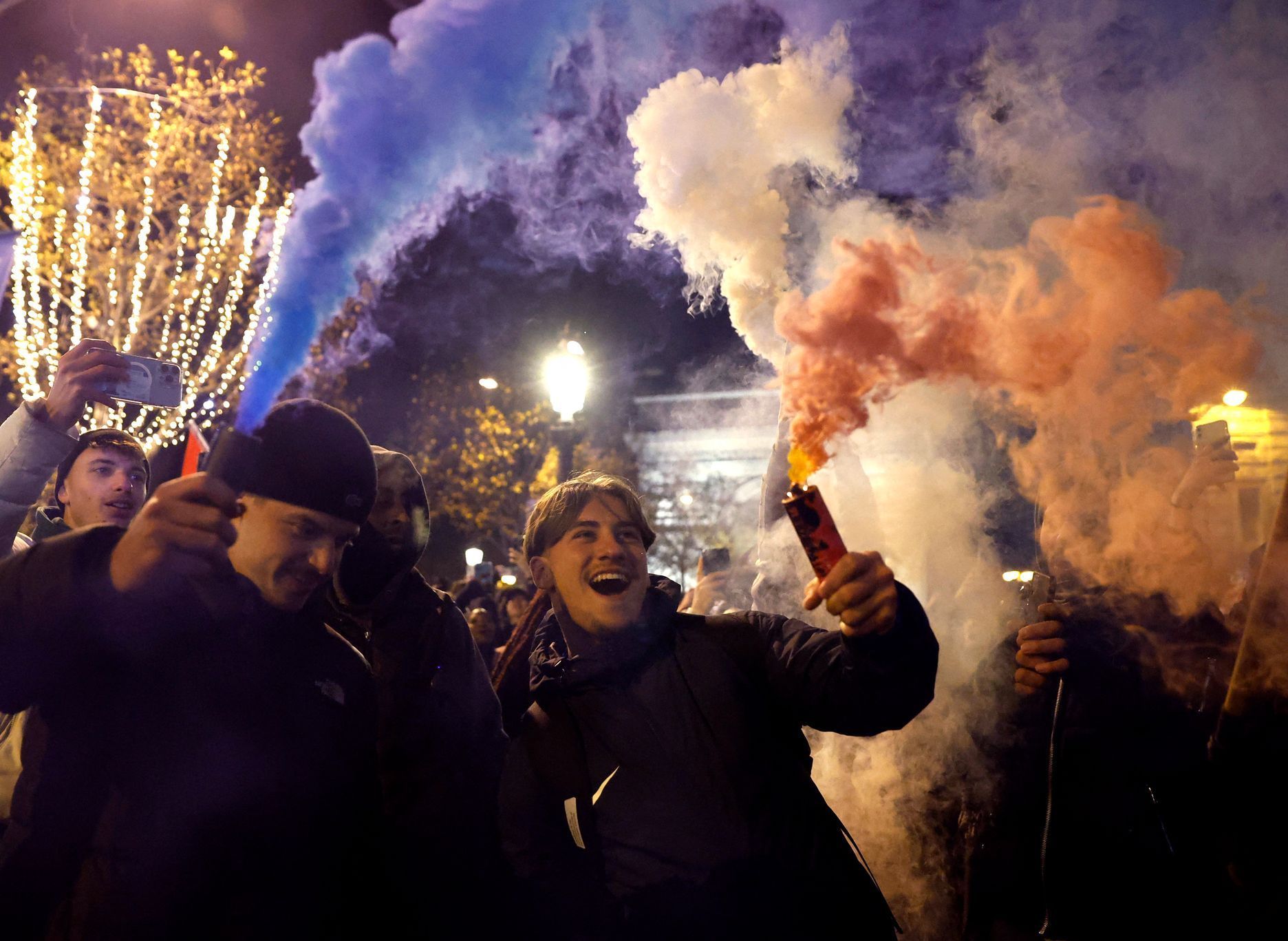Francouzští fanoušci na Champs-Élysées v Paříži slaví po semifinále MS 2022 Francie - Maroko