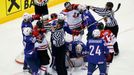 Referees intervene during a scuffle between players of France and Canada in the third period of their men's ice hockey World Championship Group A game at Chizhovka Arena