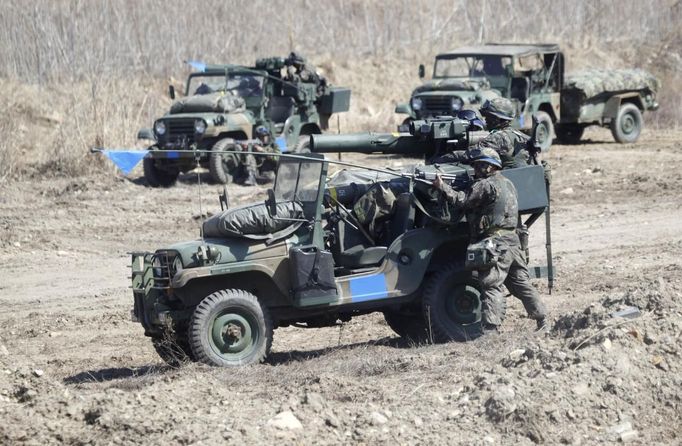 South Korean soldiers from an artillery unit participate in a military drill near the demilitarised zone separating North Korea from the South, in Paju, north of Seoul March 29, 2013. North Korea put its missile units on standby on Friday to attack U.S. military bases in South Korea and the Pacific, after the United States flew two nuclear-capable stealth bombers over the Korean peninsula in a rare show of force. North Korean leader Kim Jong-un signed off on the order at a midnight meeting of top generals and "judged the time has come to settle accounts with the U.S. imperialists in view of the prevailing situation", the official KCNA news agency said.