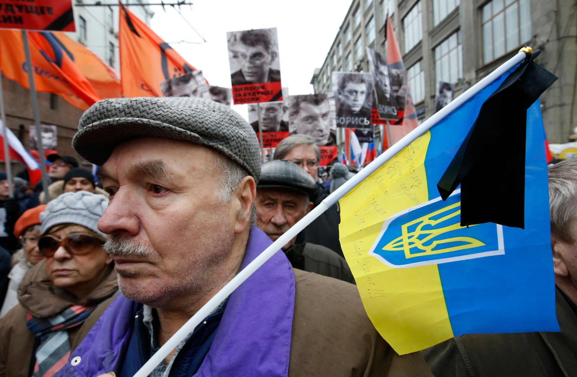 Man holds Ukrainian national flag during march to commemorate Kremlin critic Boris Nemtsov in central Moscow