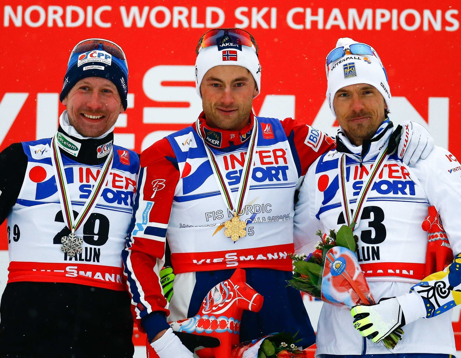 Bauer of the Czech Republic, Norway's Northug and Sweden's Olsson pose after the men's cross country 50 km mass start classic race at the Nordic World Ski Championships in Falun