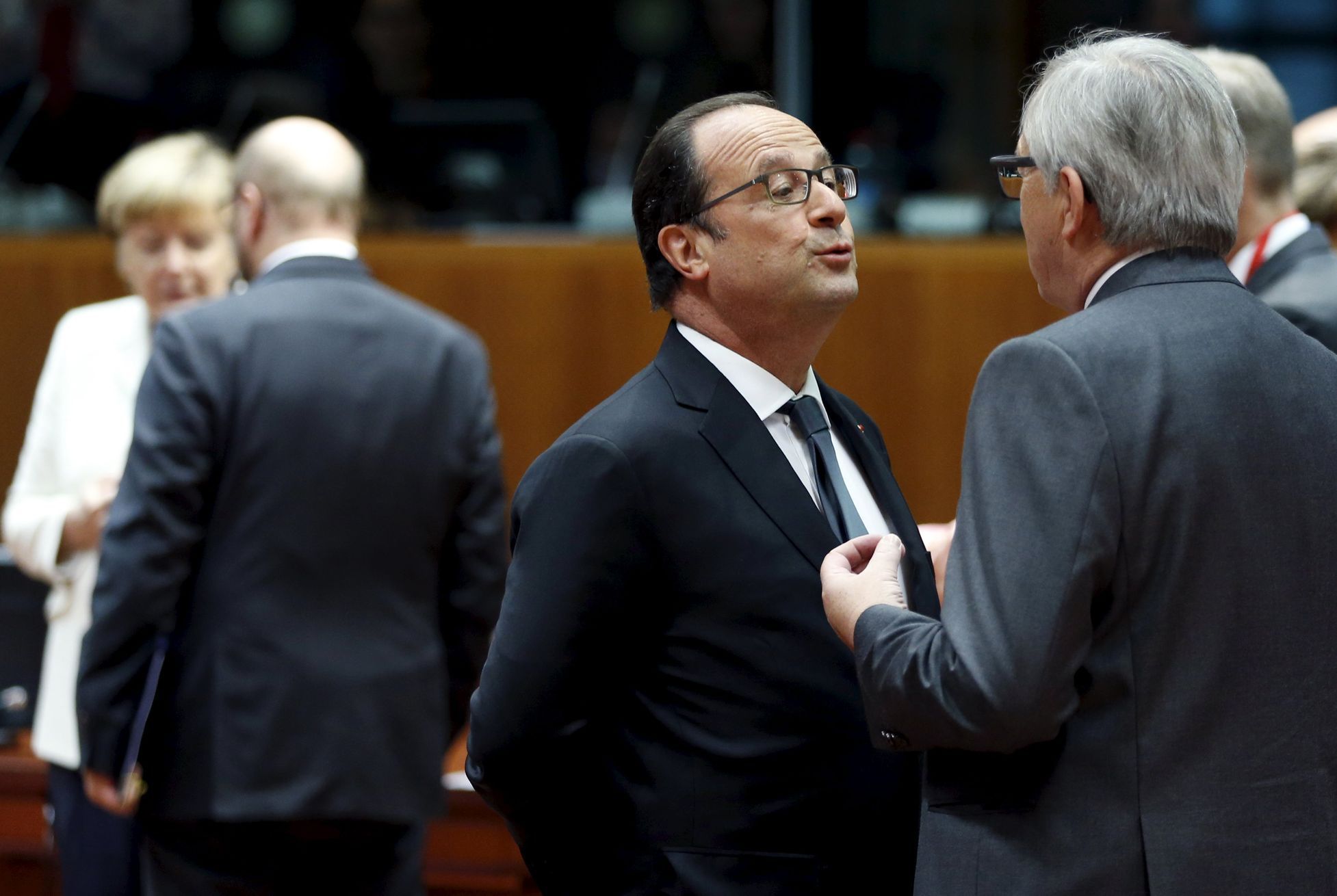 France's President Hollande talks to EU Commission President Juncker during an euro zone leaders summit in Brussels