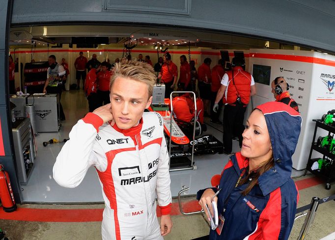 Marussia Formula One driver Max Chilton of Britain watches from the pit lane during first practice ahead of the British Grand Prix at the Silverstone Race circuit, centra