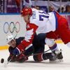 Team USA's Parise and Russia's Yemelin battle for the puck during the first period of their men's preliminary round ice hockey game at the Sochi 2014 Winter Olympic Games