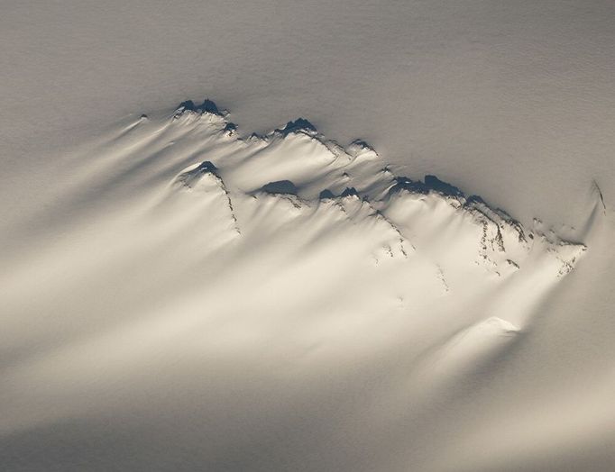 Aerial of a windswept nunatak on the Harding Ice Field in Kenai Fjords National Park, Southcentral Alaska, Winter