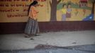 A woman walks past the blood stain of a man who was lynched and burnt alive by a mob after killing two children in a classroom at a primary school in Tactic, in Alta Verapaz region, some 189km (117 miles) from Guatemala City, September 12, 2012. According to local media, a man entered a school and killed two children, a 8-year-old and a 13-year-old, with a machete. REUTERS/Jorge Dan Lopez (GUATEMALA - Tags: EDUCATION CRIME LAW) Published: Zář. 13, 2012, 1:30 dop.