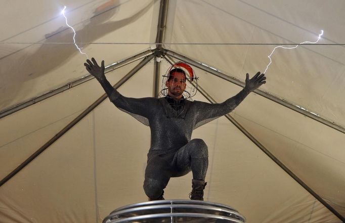 Magician David Blaine performs a demonstration of his upcoming performance "Electrified" during a press briefing in New York, October 2, 2012. During the performance Blaine will wear a custom made metal suit while standing on a 20-foot-high (6 meter) platform on New York City's Pier 54 on the edge of the Hudson River while surrounded by seven metallic orbs, or tesa coils, that will stream 1 million volts of electricity around him for 3 days and nights. REUTERS/Mike Segar (UNITED STATES - Tags: SOCIETY ENTERTAINMENT) Published: Říj. 2, 2012, 6:54 odp.