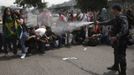 A police officer uses pepper spray on supporters of a native Indian community living at the Brazilian Indian Museum during a protest against the community's eviction in Rio de Janeiro March 22, 2013. Brazilian military police took position early morning outside the abandoned museum, where the community of around 30 native Indians have been living in since 2006. The community was ordered to leave the museum in 72 hours by court officials since last week, local media reported. Most of the Indians later left the museum after making a deal with the authorities. REUTERS/Ricardo Moraes (BRAZIL - Tags: CIVIL UNREST POLITICS REAL ESTATE BUSINESS SOCIETY TPX IMAGES OF THE DAY) Published: Bře. 22, 2013, 4:53 odp.