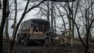 Ukrainian service members unload howitzer shells from a truck at a position near the front line town of Bakhmut, amid Russia's attack on Ukraine, in Donetsk region, Ukrai