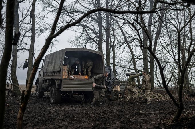 Ukrainian service members unload howitzer shells from a truck at a position near the front line town of Bakhmut, amid Russia's attack on Ukraine, in Donetsk region, Ukrai