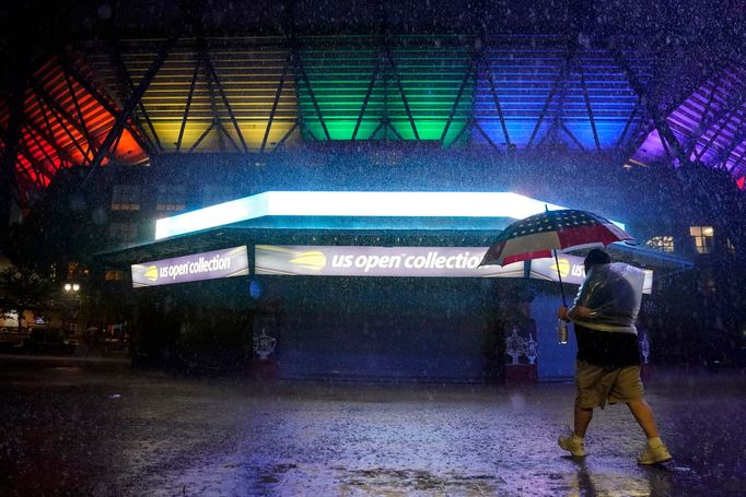 Sep 1, 2021; Flushing, NY, USA; A man walks by the flooded pavilion along Arthur Ashe Stadium on day three of the 2021 U.S. Open tennis tournament at USTA Billie Jean Kin