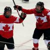 Canada's Poulin celebrates her gold medal-winning overtime goal against Team USA with teammate Wickenheiser at the Sochi 2014 Winter Olympic Games