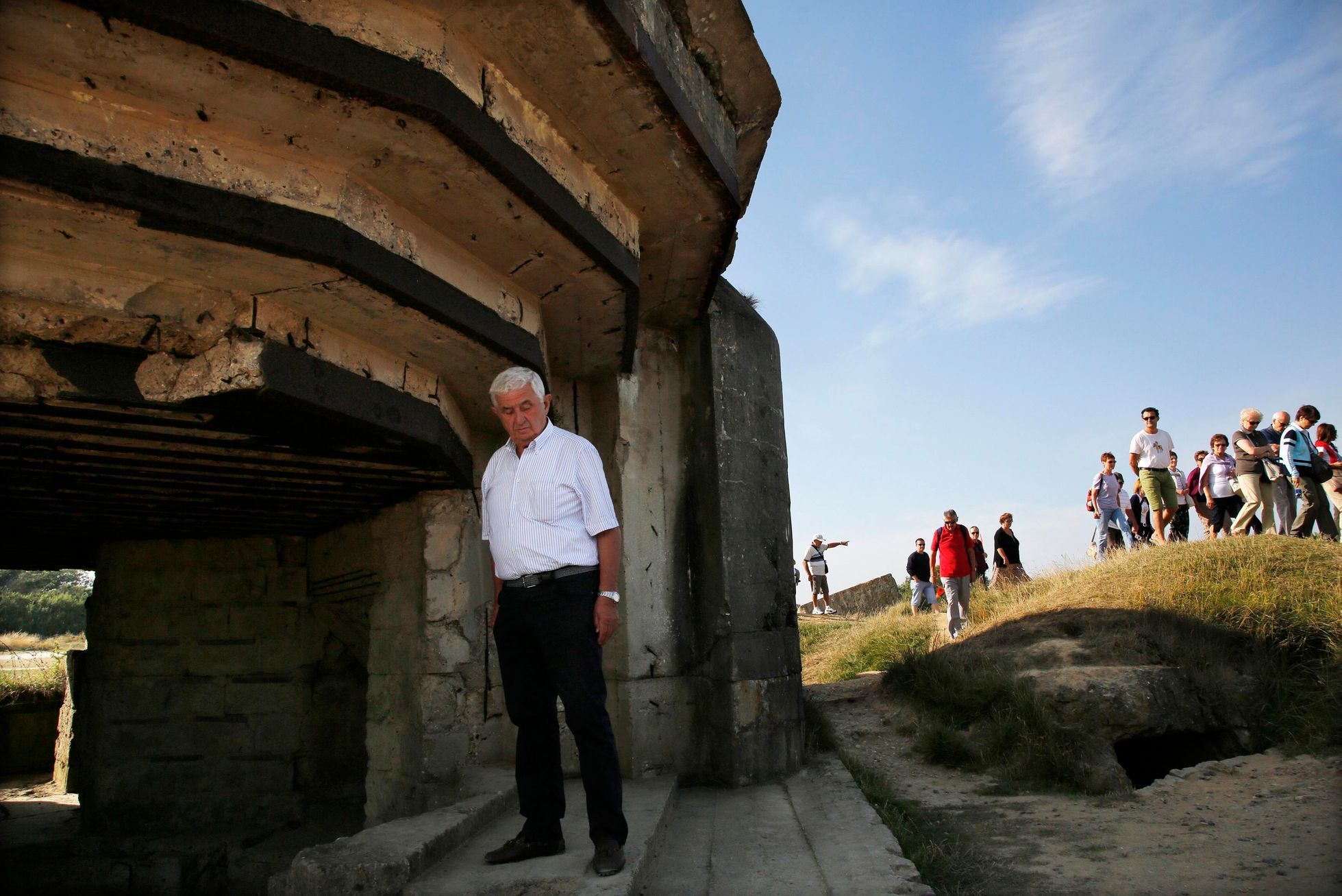 An Italian tourist views a bunker at a strategic site overlooking the D-Day beaches which had been captured by U.S. Army Rangers at Pointe du Hoc