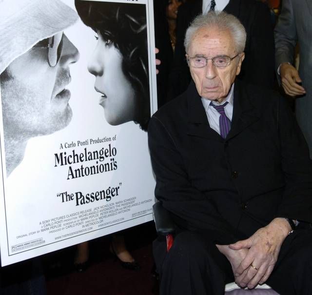 Michelangelo Antonioni na archivním snímku u plakátu svého filmu