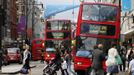 Double decker buses drive past posters of Olympic Rings and flags advertising the London 2012 Olympics at Oxford Street in London July 13, 2012. The London 2012 Olympics run from July 27 to August 12. REUTERS/Fabrizio Bensch (BRITAIN - Tags: SPORT OLYMPICS TRANSPORT) Published: Čec. 13, 2012, 2:40 odp.