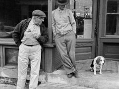 Two men and a dog in a rural town in Iowa, 1963.