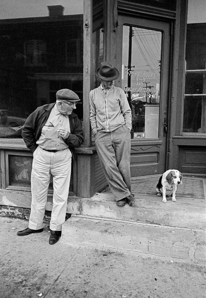 Two men and a dog in a rural town in Iowa, 1963.