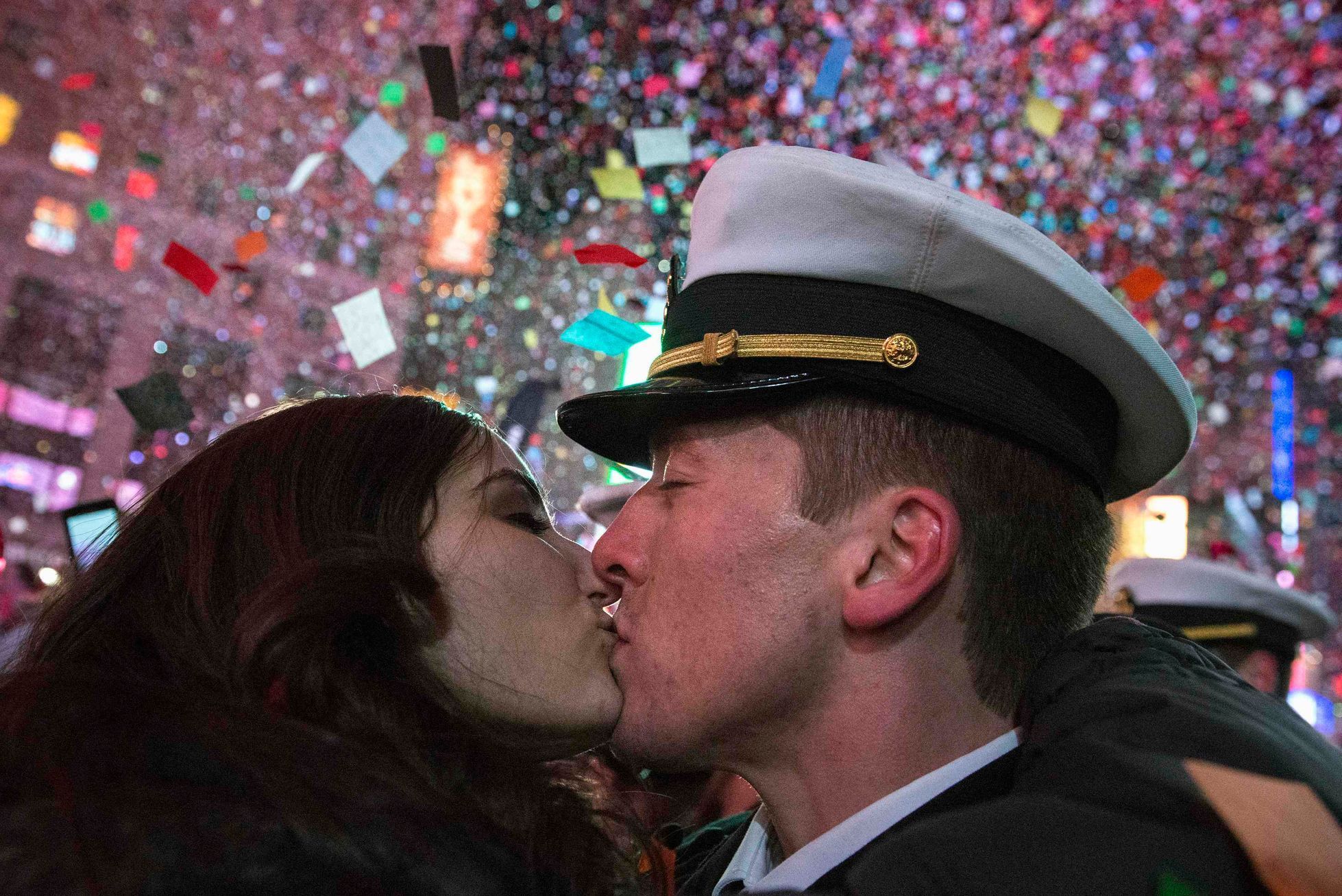 A couple kisses amid confetti as the clock strikes midnight during New Year's Eve celebrations in Times Square, New York