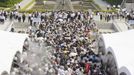 People wait in queue to offer prayers for the victims of the 1945 atomic bombing, in the Peace Memorial Park in Hiroshima August 6, 2013, on the 68th anniversary of the world's first atomic bombing on the city. Mandatory Credit. REUTERS/Kyodo (JAPAN - Tags: ANNIVERSARY CONFLICT) ATTENTION EDITORS - THIS IMAGE HAS BEEN SUPPLIED BY A THIRD PARTY. IT IS DISTRIBUTED, EXACTLY AS RECEIVED BY REUTERS, AS A SERVICE TO CLIENTS. FOR EDITORIAL USE ONLY. NOT FOR SALE FOR MARKETING OR ADVERTISING CAMPAIGNS. MANDATORY CREDIT. JAPAN OUT. NO COMMERCIAL OR EDITORIAL SALES IN JAPAN. YES Published: Srp. 6, 2013, 1:52 dop.