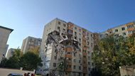 People look at the damage caused by an explosion at an apartment block, in Bucharest