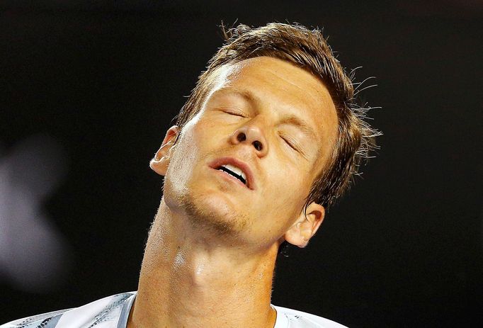 Tomas Berdych of Czech Republic reacts after missing a shot to Andy Murray of Britain during men's singles semi-final match at the Australian Open 2015 tennis tournament