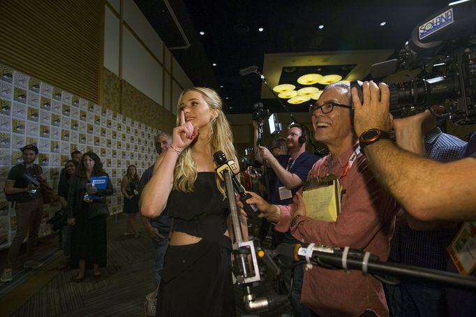 Cast member Lawrence gestures at co-star Hutcherson at a press line for &quot;The Hunger Games: Mockingjay - Part 2&quot; during the 2015 Comic-Con International Conventi