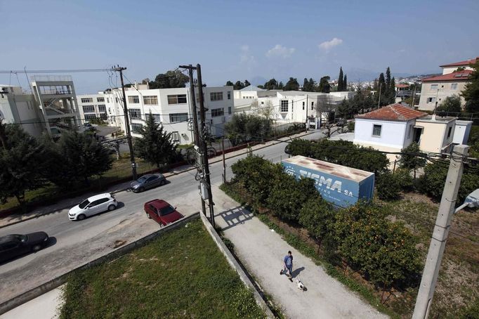 Thanos Kehagias walks with his mother's dog Vagos to the college where he is studying mechanical engineering in the Greek city of Patra