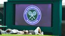 REFILE - CORRECTING TYPO Spectators lay on the grass on Murray Mound before the start of play at the Wimbledon Tennis Championships, in London June 25, 2013. REUTERS/Toby