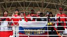 Fans stand during a one minute silence to show respect for the missing Malaysia Airlines flight MH370 before the start of the Malaysian F1 Grand Prix at Sepang Internatio