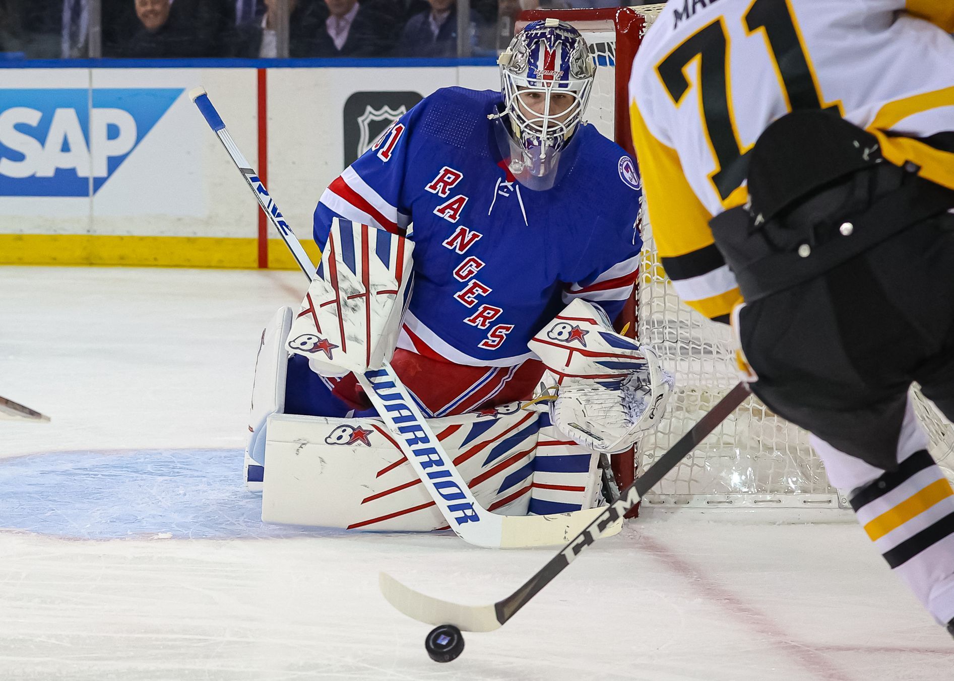 New York Rangers goaltender Igor Shesterkin (31) defends the net as Pittsburgh Penguins center Evgeni Malkin