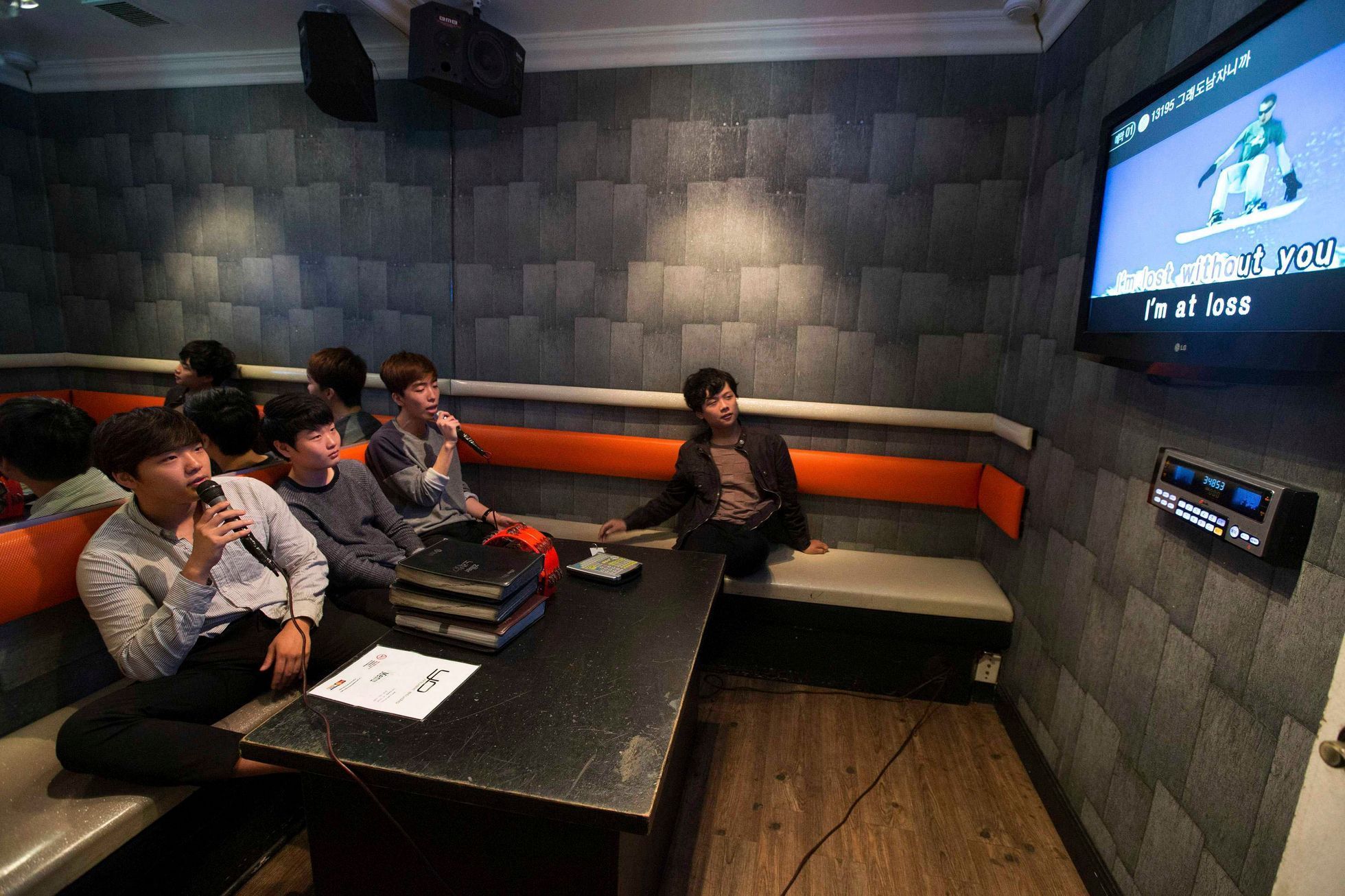 Sung Min See and his friends sing in a karaoke cafe in the Koreatown area of Los Angeles