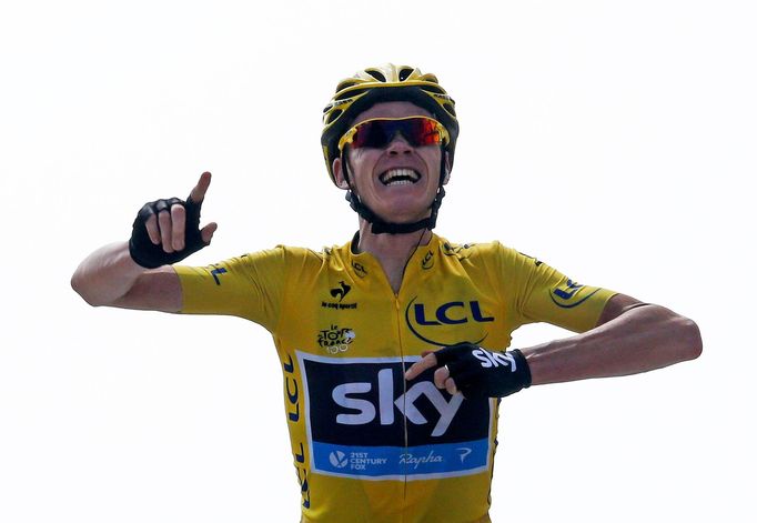 Race leader's yellow jersey Team Sky rider Christopher Froome of Britain crosses the finish line to win the 242.5 km fifteenth stage of the centenary Tour de France cycli