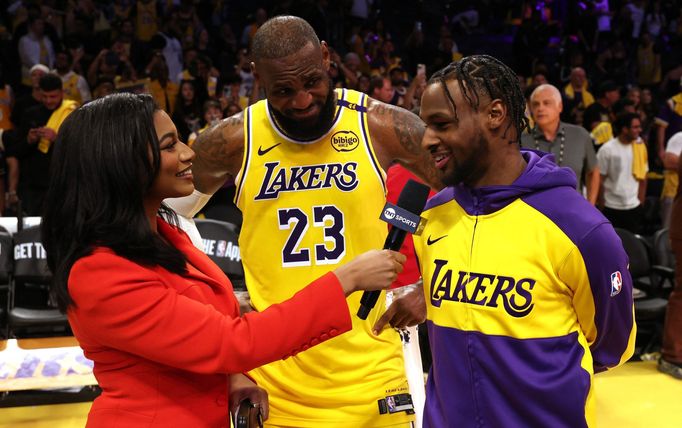 Oct 22, 2024; Los Angeles, California, USA; NBA on TNT sideline reporter Taylor Rooks interviews Los Angeles Lakers forward LeBron James (23) and guard Bronny James (9) a