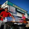 Man cooks meat in a shopping cart in the Westlake area of Los Angeles